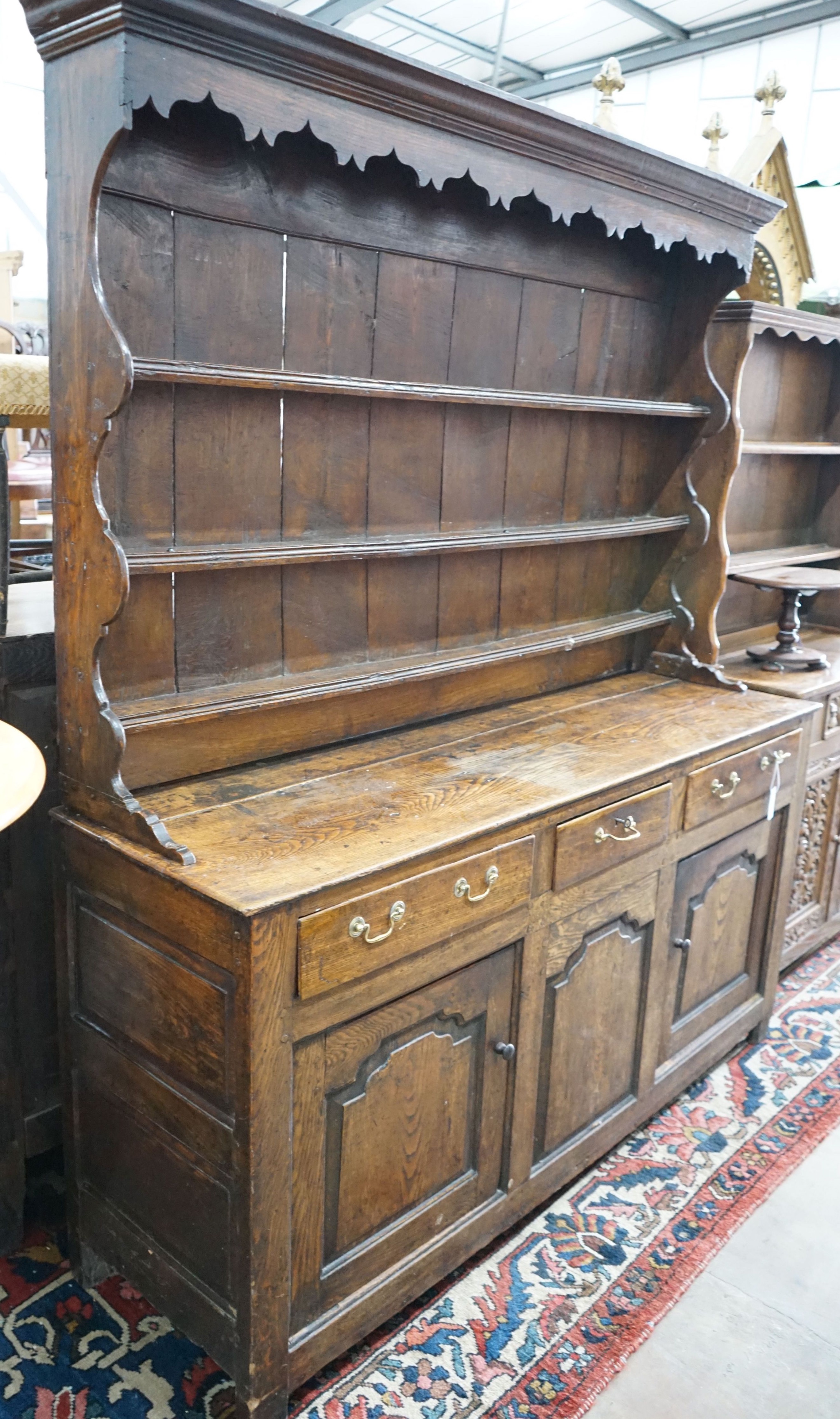 An 18th century oak dresser with boarded rack, length 172cm, depth 50cm, height 198cm